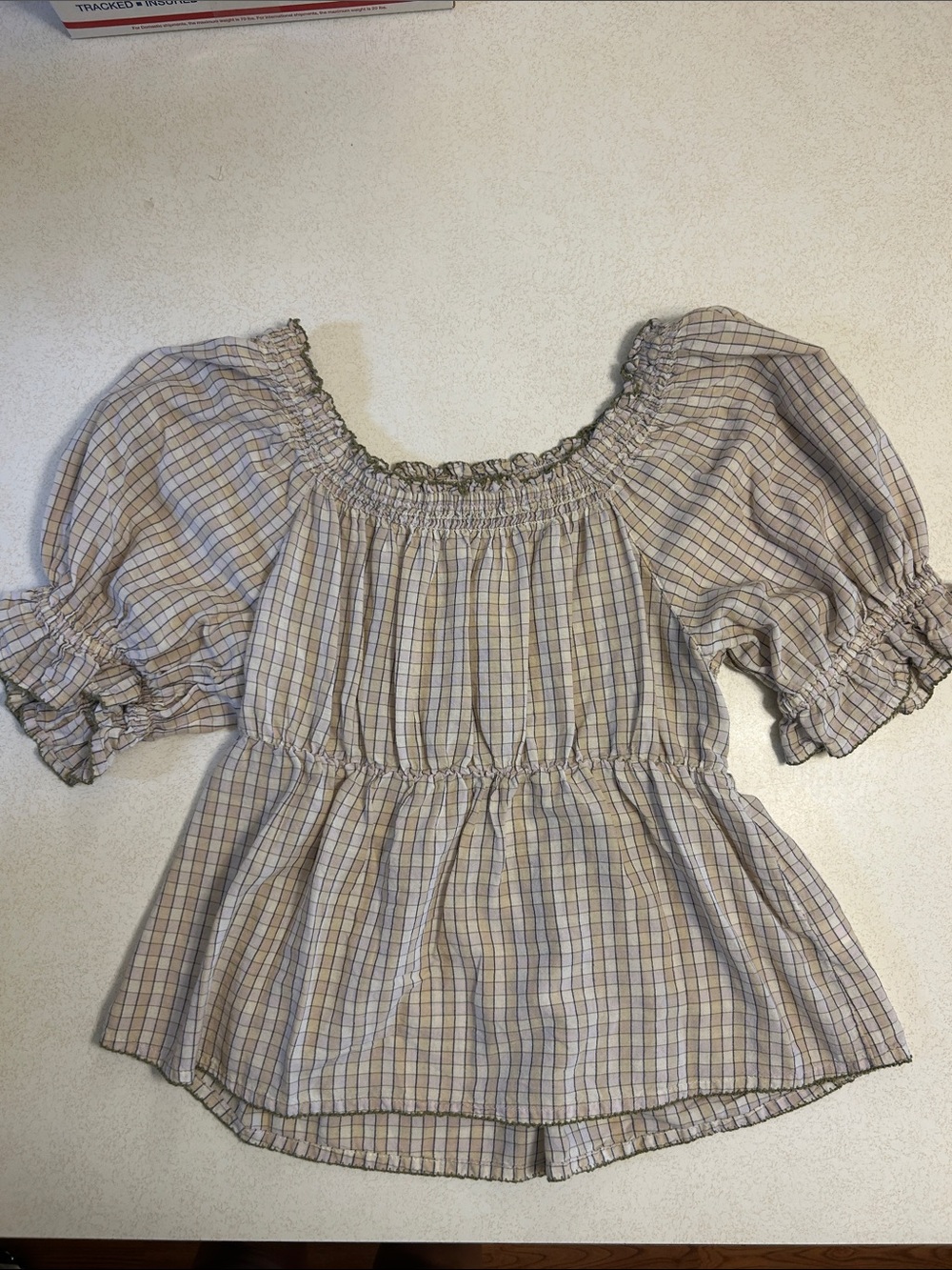 Smocked Off-Shoulder Plaid Peplum Top in Beige